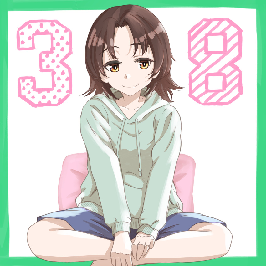 1girl absurdres bangs blue_shorts border brown_eyes brown_hair casual closed_mouth commentary drawstring girls_und_panzer green_border green_hoodie highres hood hood_down hoodie indian_style long_sleeves looking_at_viewer oritako parted_bangs pillow sawa_azusa short_hair shorts sitting smile solo