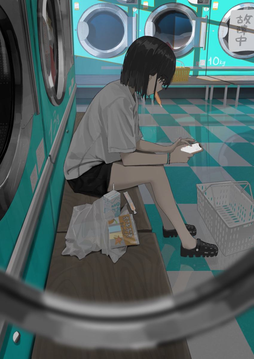 1girl 38_(sanjuuhachi) bag bench black_footwear black_hair black_shorts bracelet cellphone checkered_floor crocs highres holding holding_phone jewelry juice_box laundromat laundry looking_down original phone plastic_bag shirt short_hair short_sleeves shorts sitting smartphone solo white_shirt