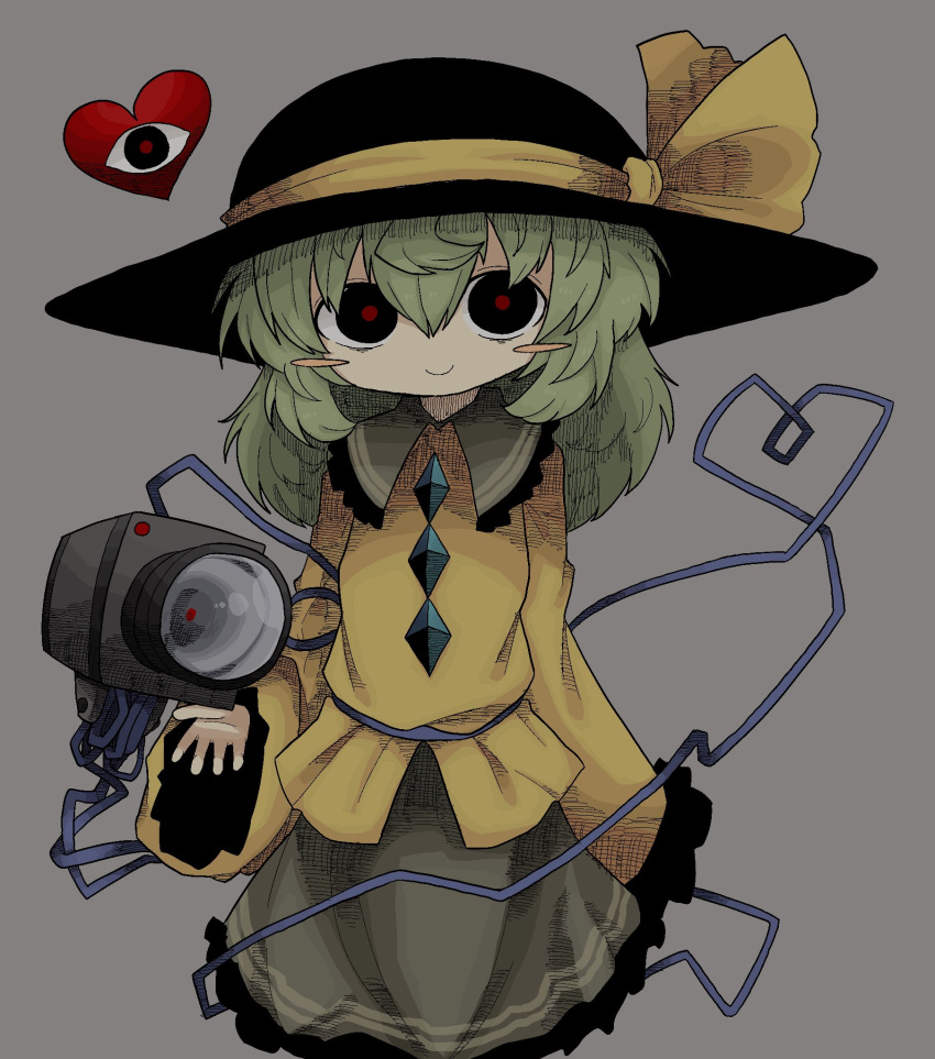 black_headwear blush buttons cable camera diamond_(shape) diamond_button green_hair green_skirt hat heart highres holding holding_camera komeiji_koishi long_sleeves medium_hair red_pupils ribbon shirt simple_background skirt sleeves_past_fingers sleeves_past_wrists smile third_eye touhou video_camera yellow_ribbon yellow_shirt zunusama