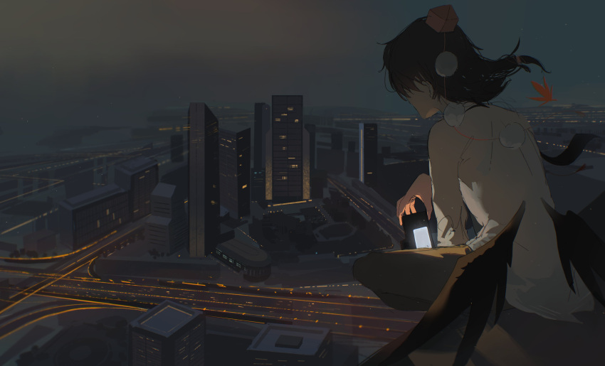1girl absurdres black_hair black_wings building camera city cityscape commentary facing_away grey_pants hat highres holding holding_camera kino2435006 medium_hair overcast pants pom_pom_(clothes) red_headwear road shameimaru_aya shirt sitting skyscraper solo tokin_hat touhou white_shirt wings