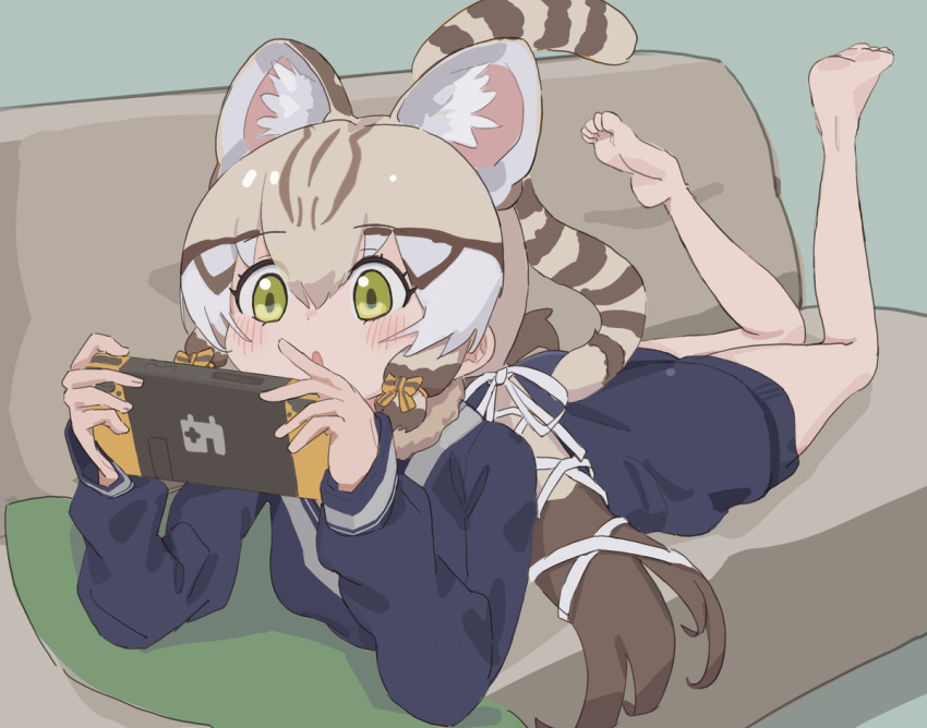 1girl animal_ears bare_legs barefoot blonde_hair blue_sweater blush bow brown_hair cat_ears cat_girl cat_tail commentary extra_ears geoffroy's_cat_(kemono_friends) green_eyes hair_bow kemono_friends kemono_friends_v_project kunikuni_(kunihiro2005) long_hair long_sleeves lying multicolored_hair nintendo_switch on_stomach sailor_collar school_uniform sidelocks solo sweater symbol-only_commentary tail the_pose twintails white_bow