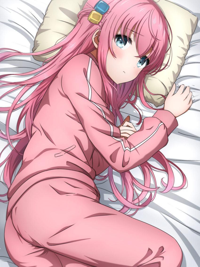 1girl absurdres blue_eyes blush bocchi_the_rock! commentary cube_hair_ornament feet_out_of_frame gotou_hitori hair_ornament highres jacket long_hair looking_at_viewer lying noshimurin on_bed on_side one_side_up pants pillow pink_hair pink_jacket pink_pants solo track_jacket track_suit