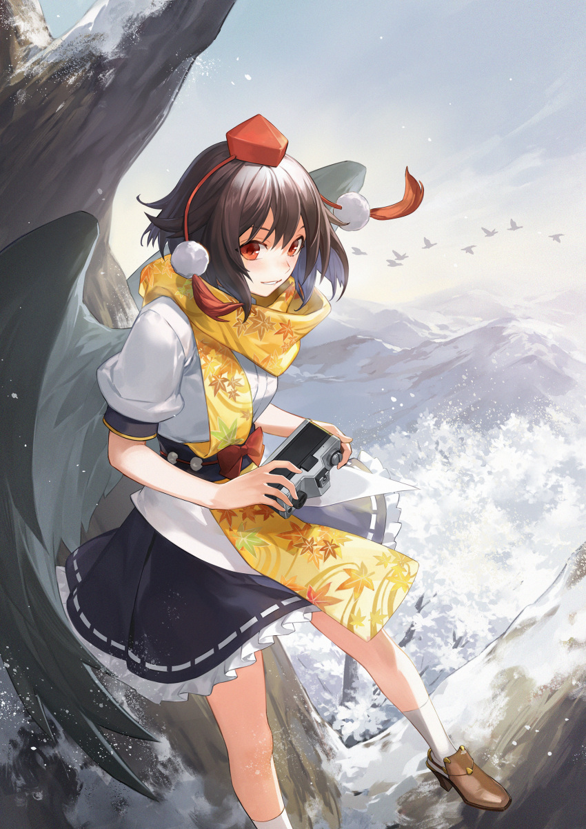 1girl absurdres bare_tree bird bird_wings black_skirt black_wings blush brown_footwear brown_hair camera commentary feathered_wings foot_out_of_frame frilled_skirt frills hakou_(barasensou) hat highres holding holding_camera leaf_print looking_at_viewer mountainous_horizon parted_lips pom_pom_(clothes) puffy_short_sleeves puffy_sleeves red_eyes red_headwear ribbon-trimmed_skirt ribbon_trim scarf shameimaru_aya shirt short_hair short_sleeves skirt smile snow socks solo tokin_hat touhou tree white_shirt white_socks wings yellow_scarf
