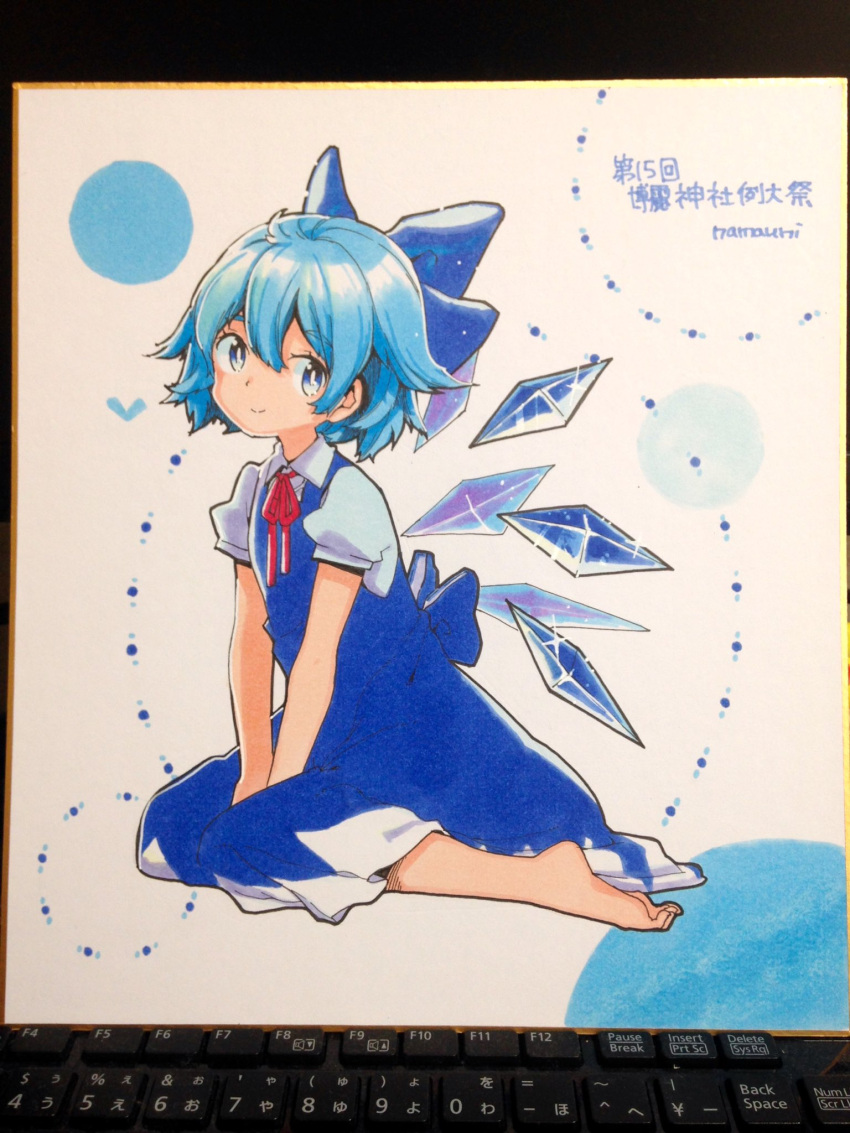 1girl artist_name bangs barefoot blue_bow blue_dress blue_eyes blue_hair bow cirno closed_mouth collared_shirt detached_wings dress fairy full_body hair_between_eyes hair_bow highres ice ice_wings namauni photo_(medium) puffy_short_sleeves puffy_sleeves shikishi shirt short_hair short_sleeves signature smile solo touhou traditional_media white_shirt wings