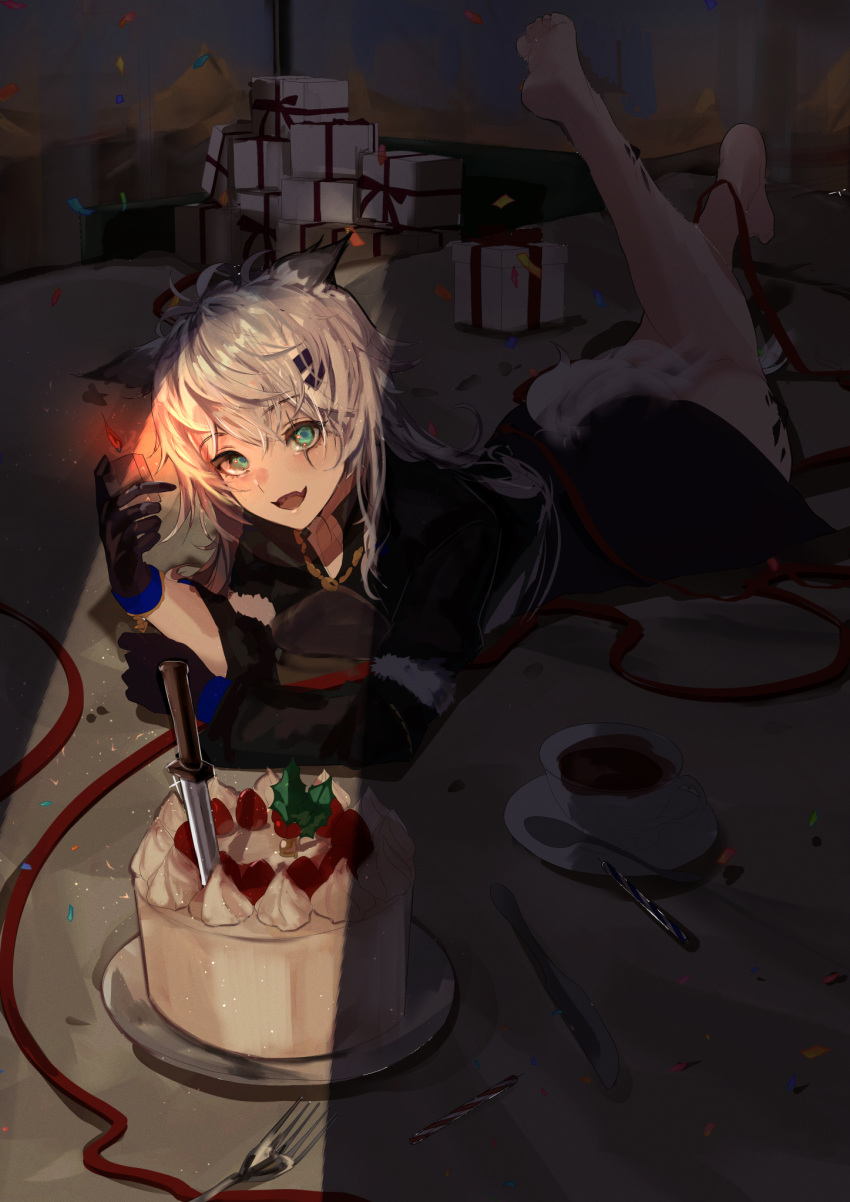 1girl :d animal_ears arknights barefoot black_gloves black_jacket blue_eyes box cake commentary_request cup fang fire food gift gift_box gloves highres holding jacket knife lappland_(arknights) leg_up lighter long_sleeves looking_at_viewer lying maria_(syake-uni) on_stomach saucer smile soles solo spoon tail tea teacup