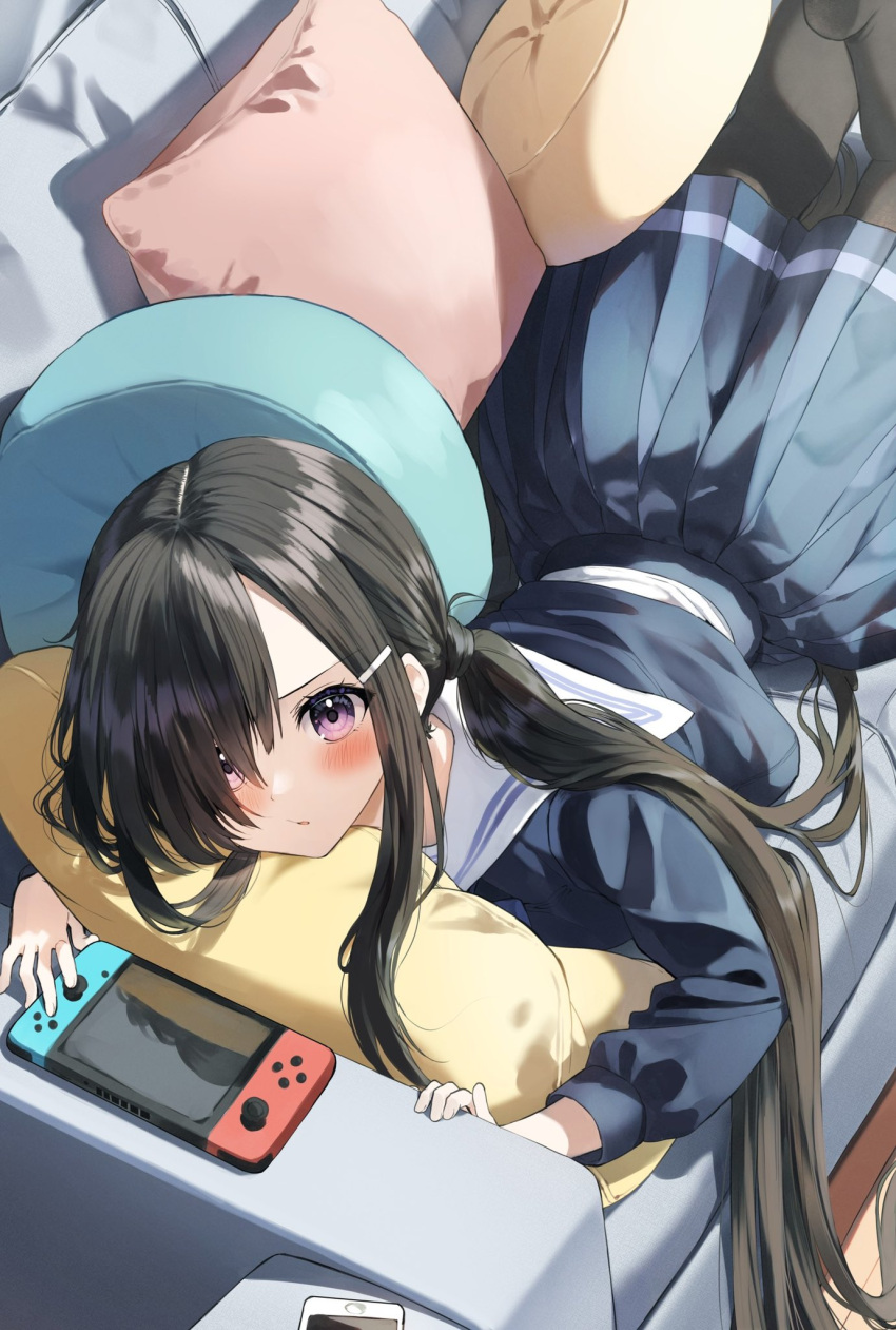 1girl bangs black_hair black_pantyhose blue_serafuku blue_shirt blue_skirt blush cellphone commentary_request couch hair_ornament hair_over_one_eye hairclip highres indoors long_hair long_sleeves looking_at_viewer low_twintails lying nintendo_switch on_couch on_stomach original pantyhose parted_lips pentagon_(railgun_ky1206) phone pillow pleated_skirt puffy_long_sleeves puffy_sleeves sailor_collar school_uniform serafuku shirt skirt solo twintails very_long_hair violet_eyes white_sailor_collar