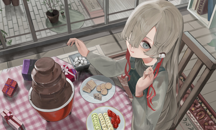 1girl :q absurdres banana basaru_1106 box chair chocolate chocolate_fountain cookie eating food fork fruit gift gift_box grey_eyes grey_hair grey_sweater hair_over_one_eye heart-shaped_box highres holding holding_fork indoors isekai_joucho kamitsubaki_studio kiwi_(fruit) kiwi_slice long_hair multicolored_hair overalls plant plate potted_plant redhead sitting solo strawberry sweater table tongue tongue_out two-tone_hair virtual_youtuber