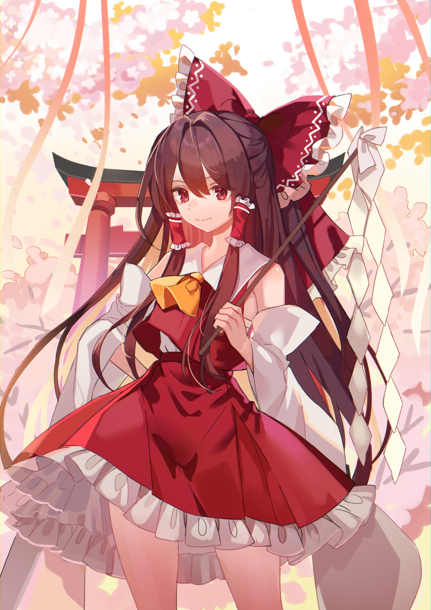 1girl absurdres ascot bangs bow brown_hair closed_mouth commentary_request cowboy_shot detached_sleeves frilled_bow frilled_hair_tubes frilled_skirt frills gohei hair_tubes hakurei_reimu hand_on_hip highres holding holding_gohei kanta_(pixiv9296614) long_hair looking_at_viewer outdoors red_bow red_eyes red_skirt red_vest sarashi shide skirt smile solo torii touhou vest white_sleeves wide_sleeves yellow_ascot