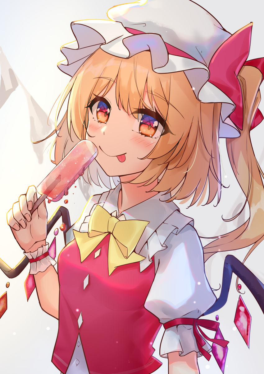 1girl :p absurdres bangs blonde_hair breasts crystal diving_penguin flandre_scarlet food grey_background hat highres holding holding_food looking_at_viewer medium_breasts mob_cap one_side_up popsicle red_eyes red_vest short_sleeves sidelighting solo tongue tongue_out touhou upper_body vest white_headwear wings wrist_cuffs