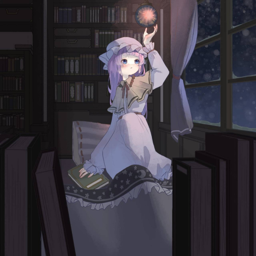 1girl :/ arm_up bangs blanket blue_eyes blunt_bangs blush book bookshelf capelet ceiling_light closed_mouth commentary cushion dress full_body hat highres indoors long_hair long_sleeves looking_outside mob_cap natomaki neck_ribbon on_bed patchouli_knowledge pink_dress pink_headwear purple_hair red_ribbon ribbon sitting snowing solo touhou white_capelet window