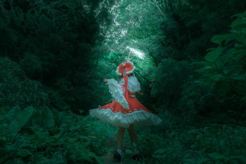 1girl black_footwear bow cosplay cosplay_photo detached_sleeves facing_away forest frilled_bow frilled_skirt frills from_behind full_body gohei hair_bow hakurei_reimu hakurei_reimu_(cosplay) highres holding holding_gohei kikuichi_monji nature outdoors photo_(medium) red_bow red_shirt red_skirt ribbon-trimmed_skirt ribbon_trim shirt skirt sleeveless sleeveless_shirt socks solo touhou tree white_socks wide_sleeves