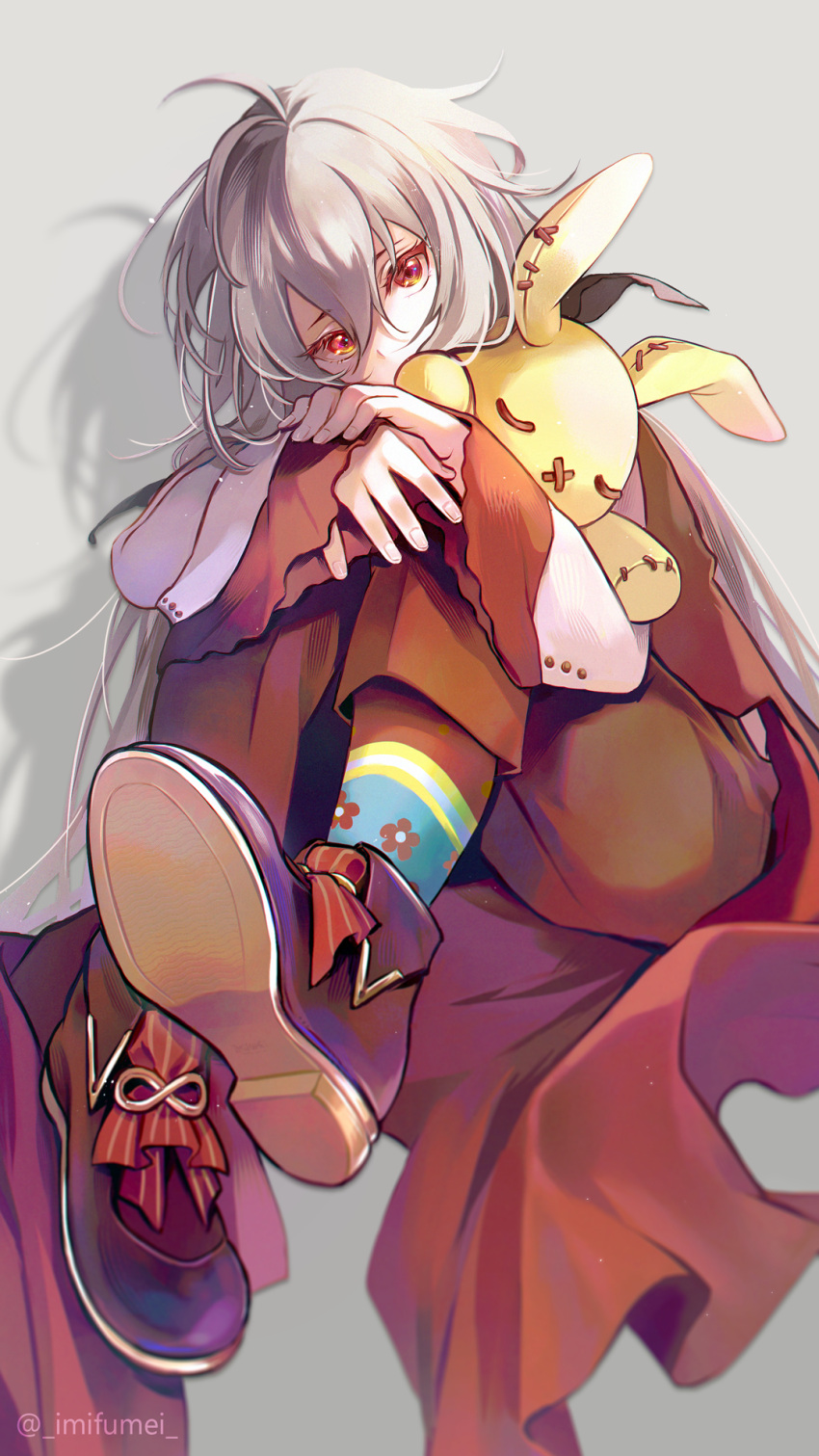 1boy ahoge androgynous ankou_(shuuen_no_virche) brown_footwear brown_pants cape grey_hair highres imi_fumei_(imifu-imifu) long_hair long_sleeves male_focus pants red_cape red_eyes shirt shoes shuuen_no_virche socks solo stuffed_animal stuffed_rabbit stuffed_toy twitter_username white_shirt