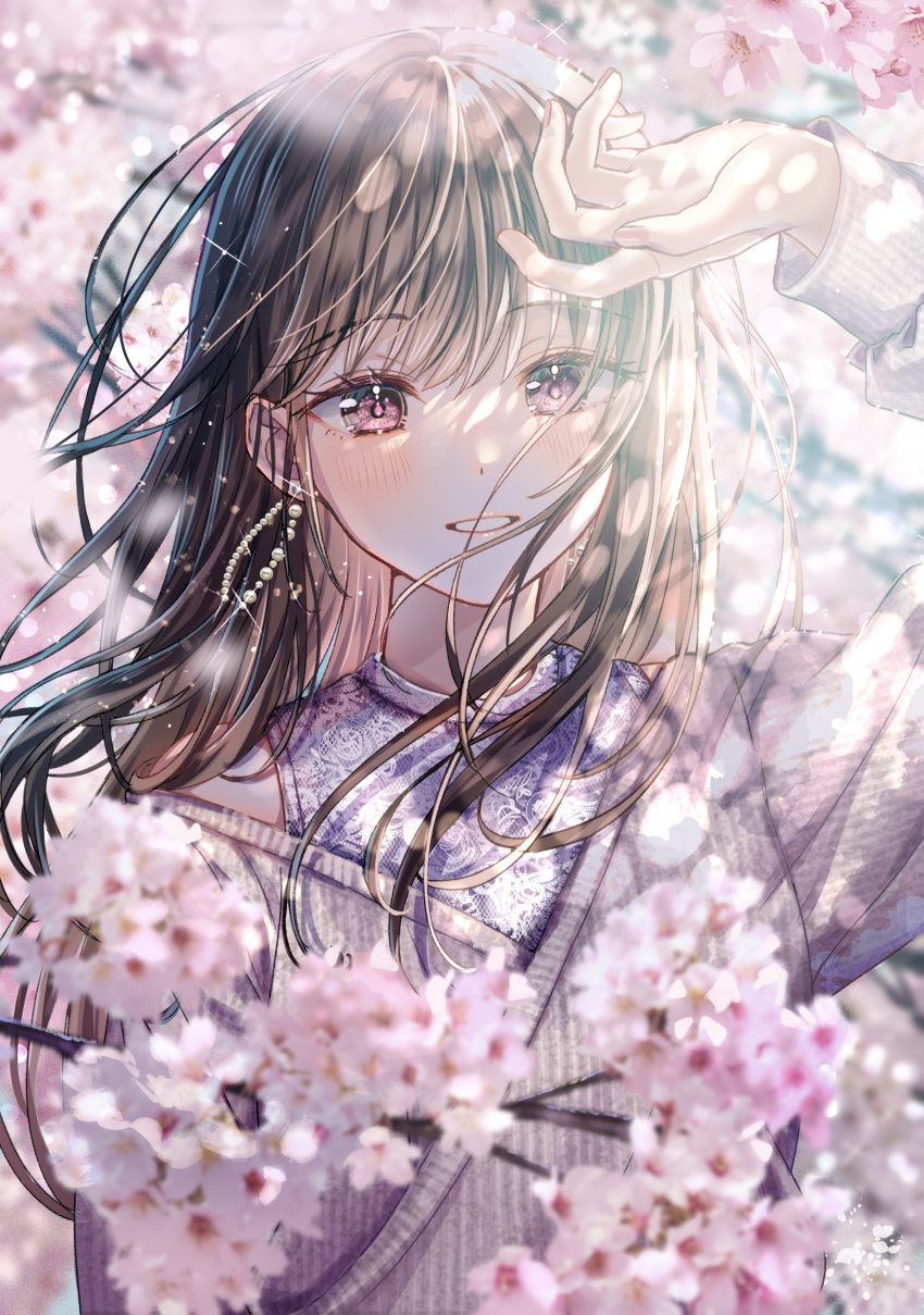 1girl absurdres blurry blurry_foreground blush brown_hair cherry_blossoms day earrings floral_print hair_over_shoulder hand_up highres jewelry long_hair long_sleeves looking_away off-shoulder_sweater off_shoulder original outdoors pink_eyes print_shirt purple_shirt sakura_(39ra) shirt sidelocks smile solo spring_(season) sunlight sweater teeth tree undershirt upper_body