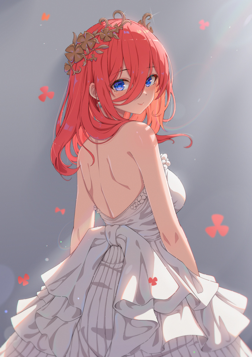 1girl absurdres arms_at_sides back backless_dress backless_outfit backlighting bare_shoulders blue_eyes blush breasts brown_hair closed_mouth commentary cowboy_shot dress earrings falling_flower flower_wreath frilled_dress frills glint go-toubun_no_hanayome grey_background hair_over_one_eye hair_over_shoulder head_tilt head_wreath highres jewelry large_breasts lens_flare light_particles lips long_hair looking_at_viewer looking_back mixed-language_commentary nakano_miku official_alternate_costume sideboob simple_background sleeveless sleeveless_dress smile solo standing wedding_dress white_dress xiayou_sieg