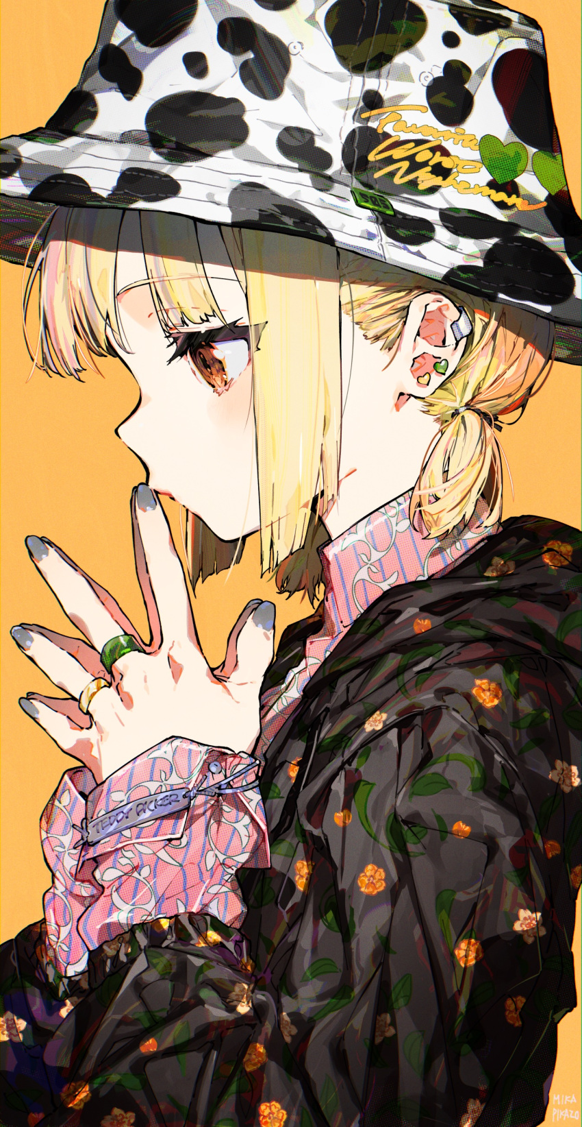 1girl absurdres animal_print black_jacket blonde_hair blunt_ends bracelet bucket_hat closed_mouth collared_shirt commentary cow_print earclip earrings english_text fingers_to_mouth floral_print from_side grey_nails hat heart heart_earrings highres jacket jewelry light_blush long_sleeves looking_down low_twintails mika_pikazo multiple_rings orange_background orange_eyes original pink_shirt print_jacket profile ring shirt short_twintails simple_background solo steepled_fingers striped striped_shirt symbol-only_commentary twintails upper_body vertical-striped_shirt vertical_stripes vine_print