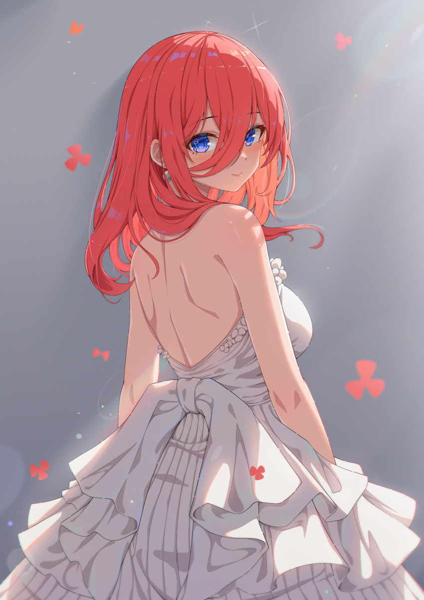 1girl absurdres arms_at_sides back backless_dress backless_outfit backlighting bare_shoulders blue_eyes blush breasts brown_hair closed_mouth commentary cowboy_shot dress earrings falling_flower frilled_dress frills go-toubun_no_hanayome grey_background hair_over_one_eye hair_over_shoulder head_tilt highres jewelry large_breasts lens_flare light_particles lips long_hair looking_at_viewer looking_back mixed-language_commentary nakano_miku official_alternate_costume sideboob simple_background sleeveless sleeveless_dress smile solo standing wedding_dress white_dress xiayou_sieg