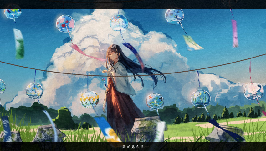 1girl black_eyes black_hair blue_sky blunt_bangs closed_mouth clouds cloudy_sky commentary day feet_out_of_frame grass hakama hakama_skirt highres holding_wind_chime japanese_clothes kimono kotomi_alpaca letterboxed long_hair long_sleeves miko original outdoors red_hakama red_skirt scenery skirt sky solo translated tree white_kimono wide_sleeves wind_chime