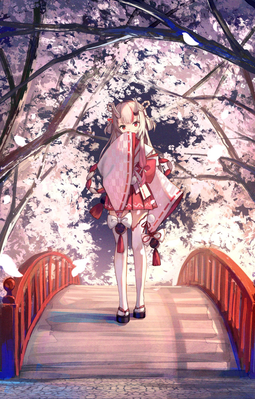 1girl braid bridge cherry_blossoms full_body gradient_hair highres hololive horns japanese_clothes kouhaku_nawa long_hair looking_at_viewer multicolored_hair nakiri_ayame oni oni_horns outdoors pleated_skirt red_skirt redhead rope shimenawa side_ponytail skirt solo standing streaked_hair thigh-highs tree virtual_youtuber white_hair white_thighhighs wide_sleeves xyunx