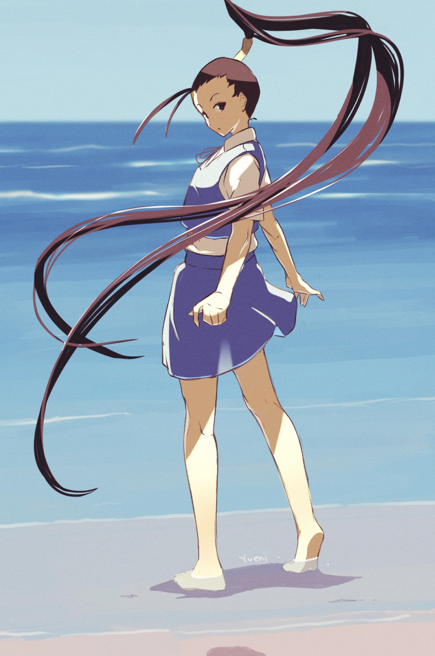 1girl antenna_hair barefoot beach brown_hair commentary_request from_behind hair_pulled_back high_ponytail highres ibuki_(street_fighter) long_hair looking_at_viewer looking_back ocean outdoors pleated_skirt ponytail sand school_uniform shore short_sleeves signature skirt solo street_fighter very_long_hair vest water yuenibushi