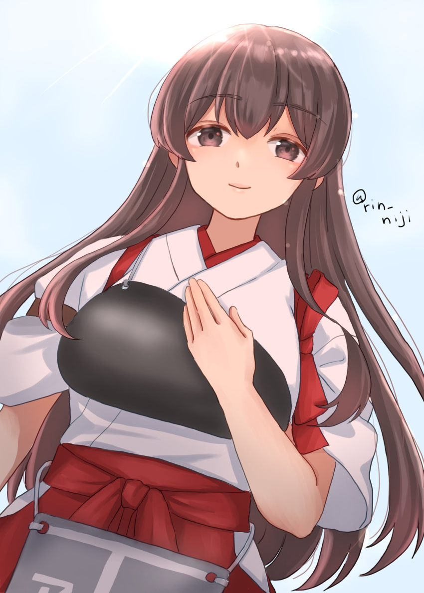 1girl akagi_(kancolle) brown_eyes brown_hair closed_mouth commentary_request day hakama hand_on_own_chest hand_on_own_hip highres japanese_clothes kantai_collection long_hair looking_at_viewer muneate outdoors red_hakama rin_(rin_niji) solo sun tasuki twitter_username upper_body