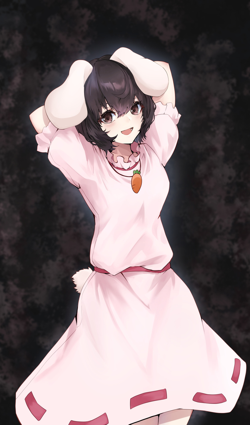 1girl :d absurdres animal_ears black_hair breasts brown_eyes carrot_necklace cowboy_shot dark_background dress floppy_ears hair_between_eyes highres inaba_tewi jewelry looking_at_viewer lower_teeth_only necklace open_mouth pink_dress puffy_short_sleeves puffy_sleeves rabbit_ears rabbit_tail short_hair short_sleeves simple_background small_breasts smile solo tail teeth touhou violet_eyes yagoro_kusuriya