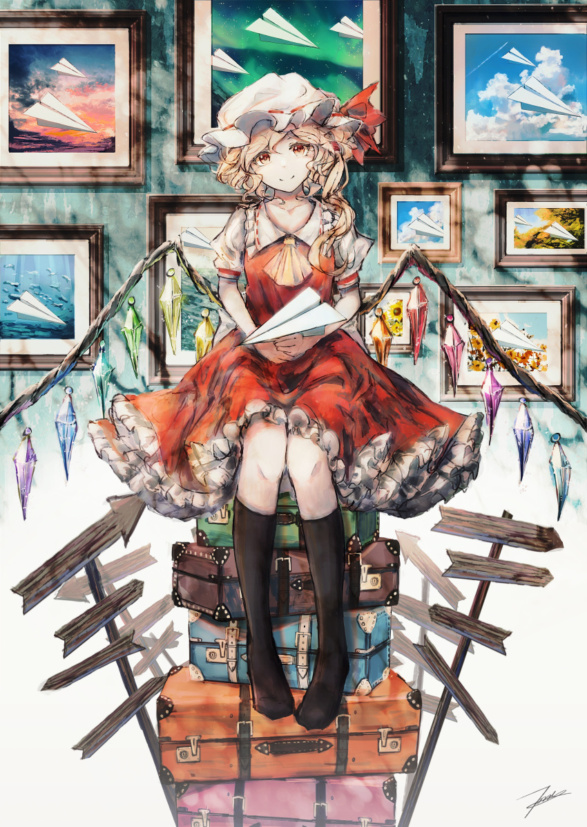 1girl absurdres ascot black_socks blonde_hair closed_mouth collared_shirt crystal flandre_scarlet frilled_shirt_collar frilled_skirt frills hat highres kneehighs long_hair looking_at_viewer mob_cap paper_airplane picture_(object) red_eyes red_skirt red_vest shirt short_sleeves side_ponytail signature sitting skirt smile socks solo suitcase tonan_(l0l0l0l0l0l) touhou vest white_headwear white_shirt wings yellow_ascot