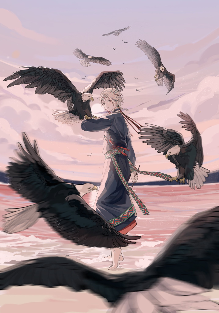 1boy androgynous animal animal_on_arm arm_at_side barefoot bird bird_on_arm blue_robe choker clouds commentary eagle earrings forehead_jewel from_behind gem grey_hair hair_ornament headband highres holding holding_stick horizon jewelry jyuroku_(blacksugar_16) landing light_particles long_sleeves looking_back male_focus motion_blur necklace ocean original outdoors red_gemstone robe sash shore short_hair sky standing stick sun symbol-only_commentary traditional_clothes twilight