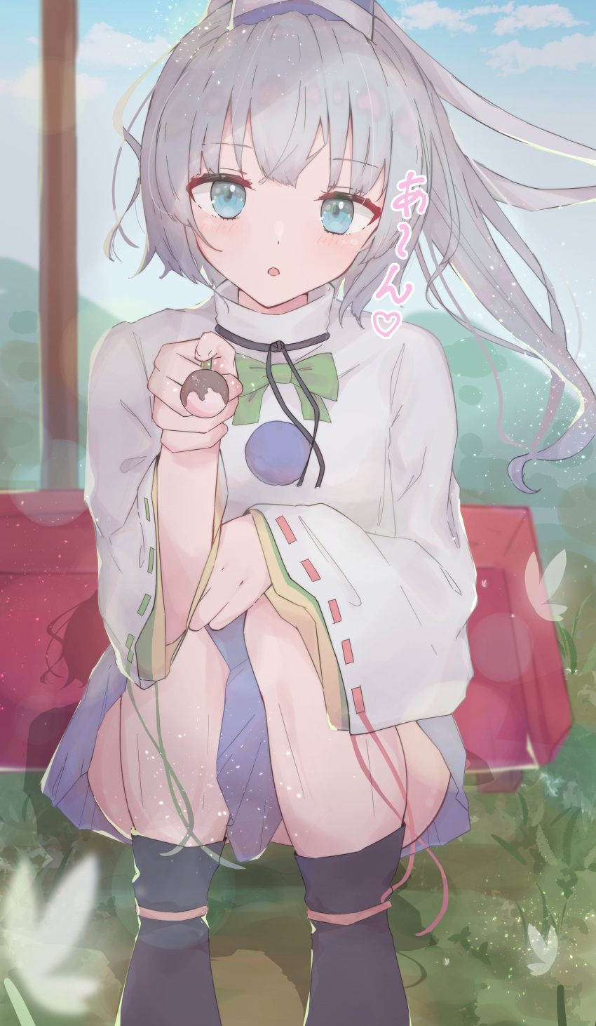 1girl absurdres black_footwear blue_eyes blue_headwear blue_sky bow bowtie commentary flower food full_body green_bow green_bowtie grey_hair hat highres holding holding_food japanese_clothes kariginu long_hair looking_at_viewer matcha_yado mononobe_no_futo open_mouth pom_pom_(clothes) ponytail ribbon-trimmed_sleeves ribbon_trim sitting sky solo tate_eboshi touhou wide_sleeves