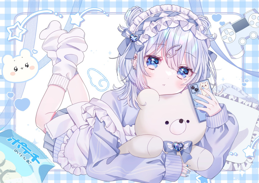 1girl apron azarashi6 blue_bow blue_eyes blue_hair blue_jacket blue_nails blue_theme blush bow cellphone closed_mouth controller double_bun drawn_wings frilled_apron frills full_body game_controller hair_between_eyes hair_bun highres holding holding_phone jacket jersey_maid long_sleeves looking_at_viewer loose_socks lying maid_apron maid_day maid_headdress on_stomach original pastel_colors phone pillow pleated_skirt skirt sleeves_past_wrists smartphone socks solo star_(symbol) stuffed_animal stuffed_toy teddy_bear track_jacket white_apron white_socks wing_hair_ornament
