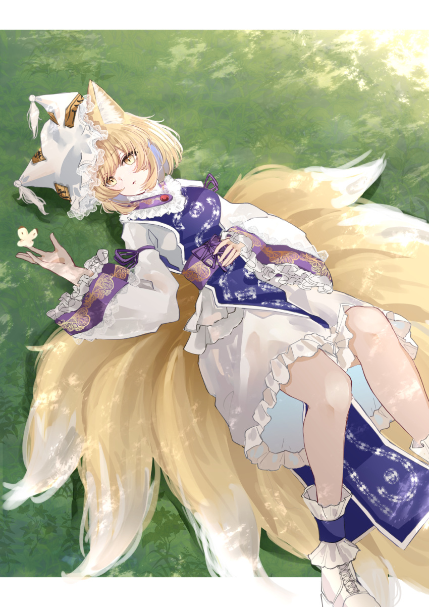 1girl animal animal_ears blonde_hair bug butterfly closed_mouth dress fox_ears fox_tail frilled_sleeves frills grass hat highres long_sleeves lying mob_cap multiple_tails on_back sarasadou_dan shoes short_hair solo tabard tail touhou white_dress white_footwear white_headwear wide_sleeves yakumo_ran yellow_eyes