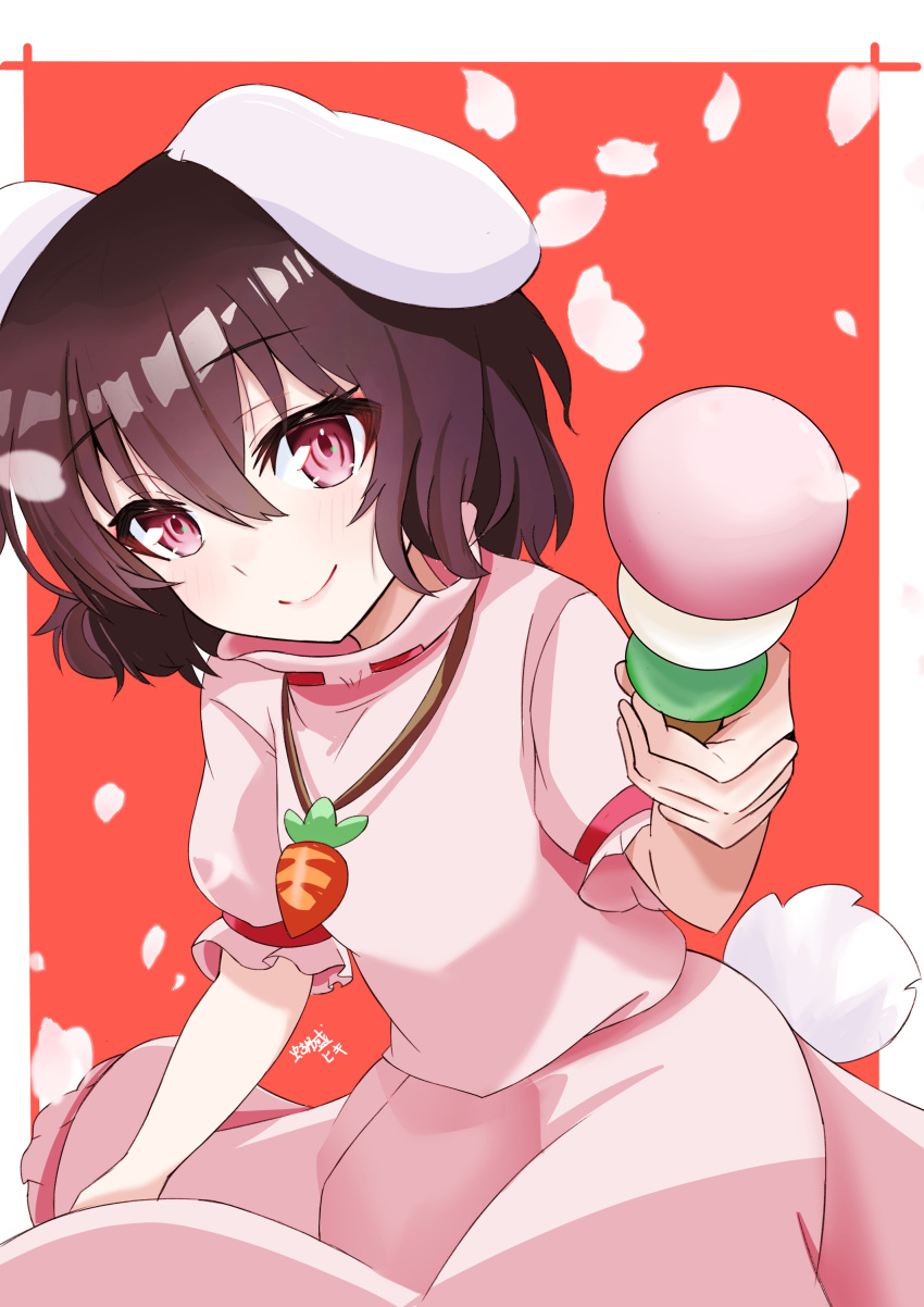 1girl absurdres animal_ears breasts brown_hair carrot_necklace closed_mouth commentary_request dango dress floppy_ears food foreshortening hair_between_eyes highres holding holding_food inaba_tewi jewelry leaning_forward light_blush looking_at_viewer necklace otsu_oki_yuhi petals pink_dress pink_eyes puffy_short_sleeves puffy_sleeves rabbit_ears rabbit_tail red_background short_hair short_sleeves signature simple_background small_breasts smile solo tail touhou wagashi