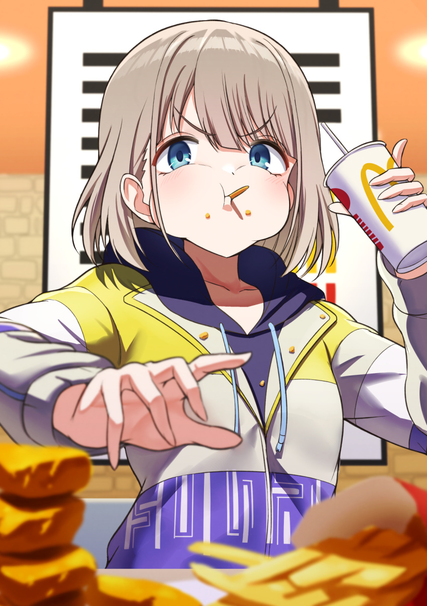 1girl blue_eyes blurry blurry_foreground cheek_bulge commentary_request cup disposable_cup eating food french_fries highres hood hoodie idolmaster idolmaster_shiny_colors indoors jacket looking_at_viewer mcdonald's osoba_susurukun puffy_cheeks restaurant serizawa_asahi short_hair solo upper_body