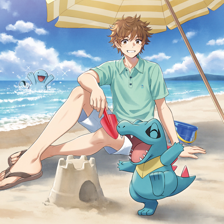 1boy ^_^ absurdres beach beach_umbrella brown_eyes brown_footwear brown_hair bucket character_print closed_eyes clouds green_shirt grin highres holding merchandise morikura_en official_art pokemon pokemon_(creature) polo_shirt quagsire sand sand_castle sand_sculpture sandals shirt short_hair short_sleeves shorts sitting sky smile sparkle striped_umbrella totodile trowel umbrella water white_shorts