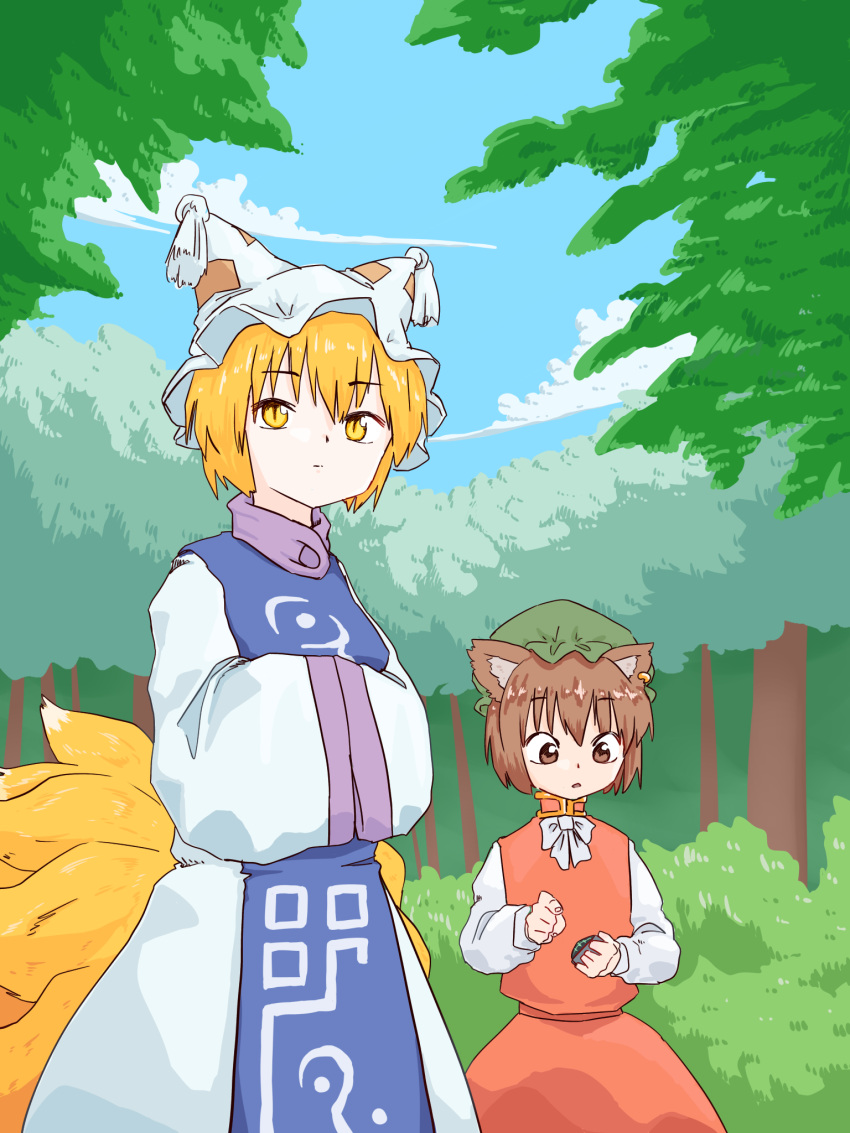 2girls animal_ears blonde_hair blue_tabard bow bowtie brown_eyes brown_hair cat_ears chen clouds commentary_request day forest fox_ears fox_tail gold_trim hands_in_opposite_sleeves hat height_difference highres looking_afar looking_down looking_to_the_side mob_cap multiple_girls multiple_tails nature outdoors petite red_skirt red_vest short_hair skirt skirt_set sky slit_pupils tabard tail tassel touhou tree user_tsnj8582 vest white_bow white_bowtie yakumo_ran yellow_eyes