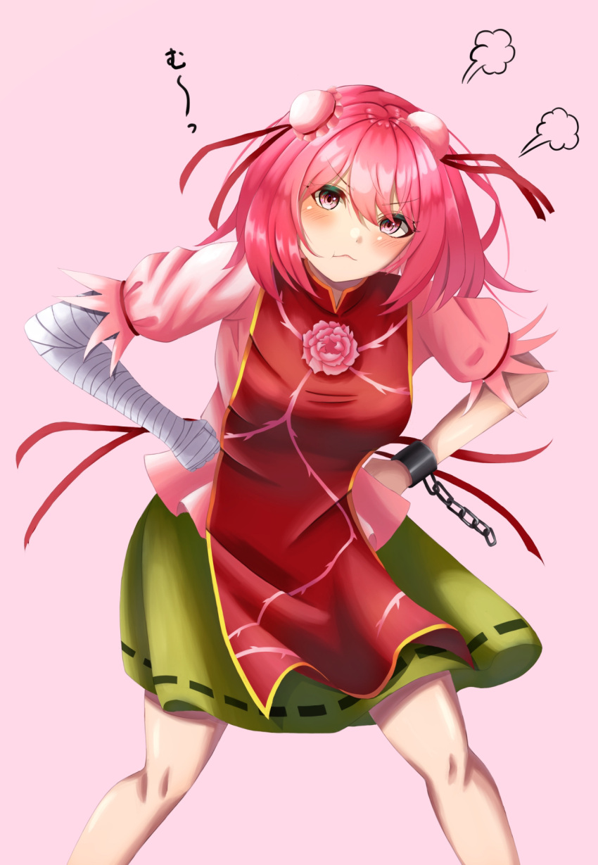 1girl bandaged_arm bandages blush bun_cover closed_mouth commentary_request cuffs double_bun flower green_skirt hair_bun hands_on_own_hips highres ibaraki_kasen looking_at_viewer meguri39 pink_background pink_eyes pink_flower pink_hair ribbon-trimmed_skirt ribbon_trim shackles short_hair short_sleeves sigh simple_background skirt solo tabard touhou