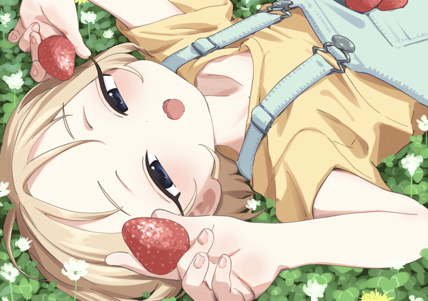 1girl blonde_hair blue_eyes bouen clover commentary_request dual_wielding dutch_angle fang field flower food forehead fruit half-closed_eyes hands_up highres holding holding_food looking_at_viewer lying on_back on_ground open_mouth original shirt short_hair short_sleeves sideways skin_fang smile solo strawberry t-shirt upper_body white_flower yellow_shirt