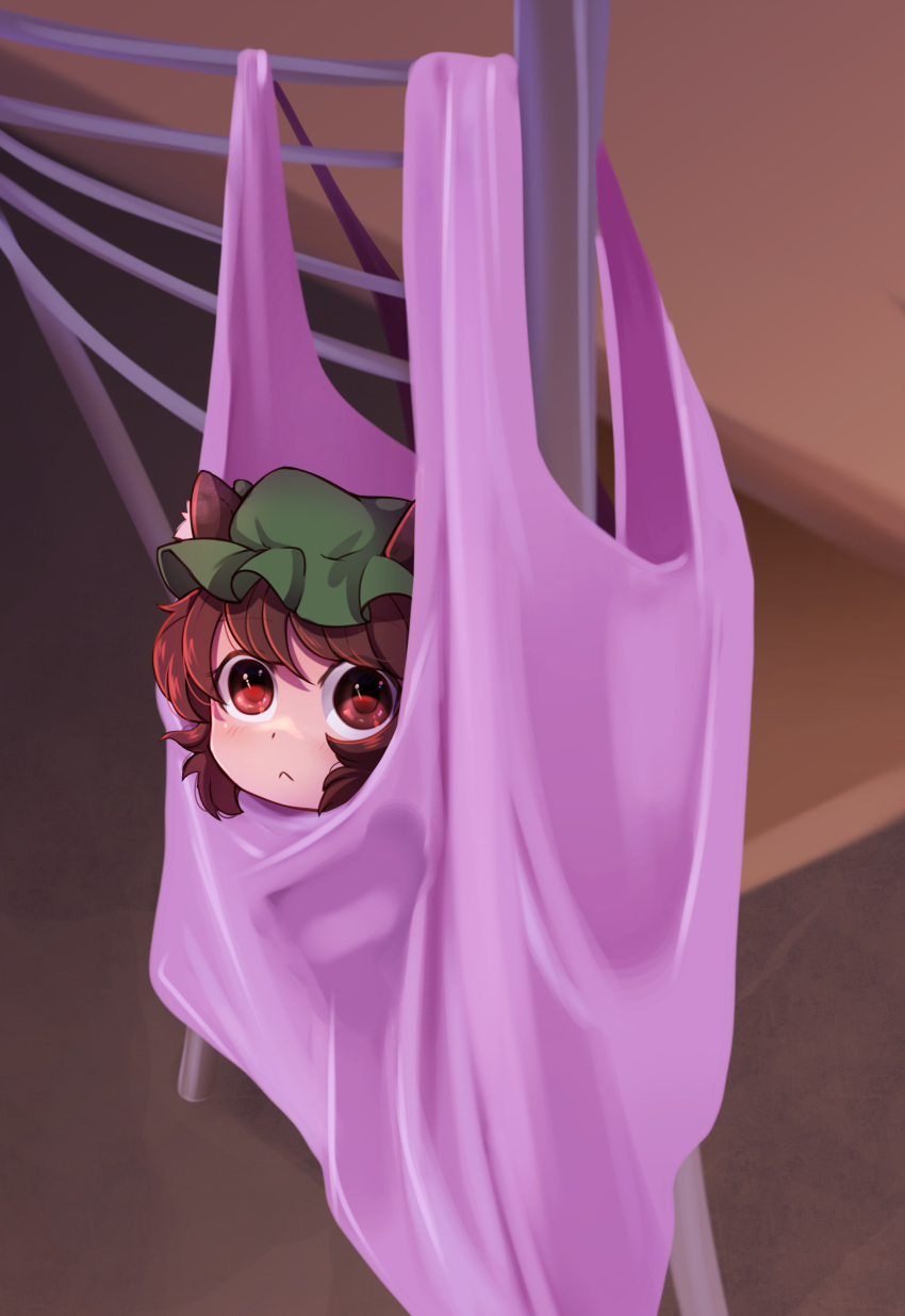 1girl :&lt; absurdres animal_ears bag blush brown_eyes brown_hair cat_ears chair chen closed_mouth commentary dungeon_toaster english_commentary green_headwear hat highres in_bag in_container looking_at_viewer mob_cap short_hair solo touhou