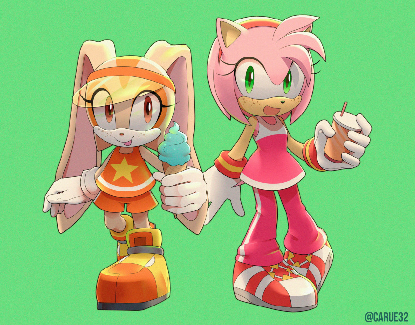 2girls amy_rose artist_name caruel_art cream_the_rabbit food gloves green_background highres holding holding_food ice_cream multiple_girls open_mouth orange_shirt orange_shorts pants pink_pants pink_shirt shirt shoes shorts simple_background sleeveless sonic_(series) tongue tongue_out watermark white_gloves