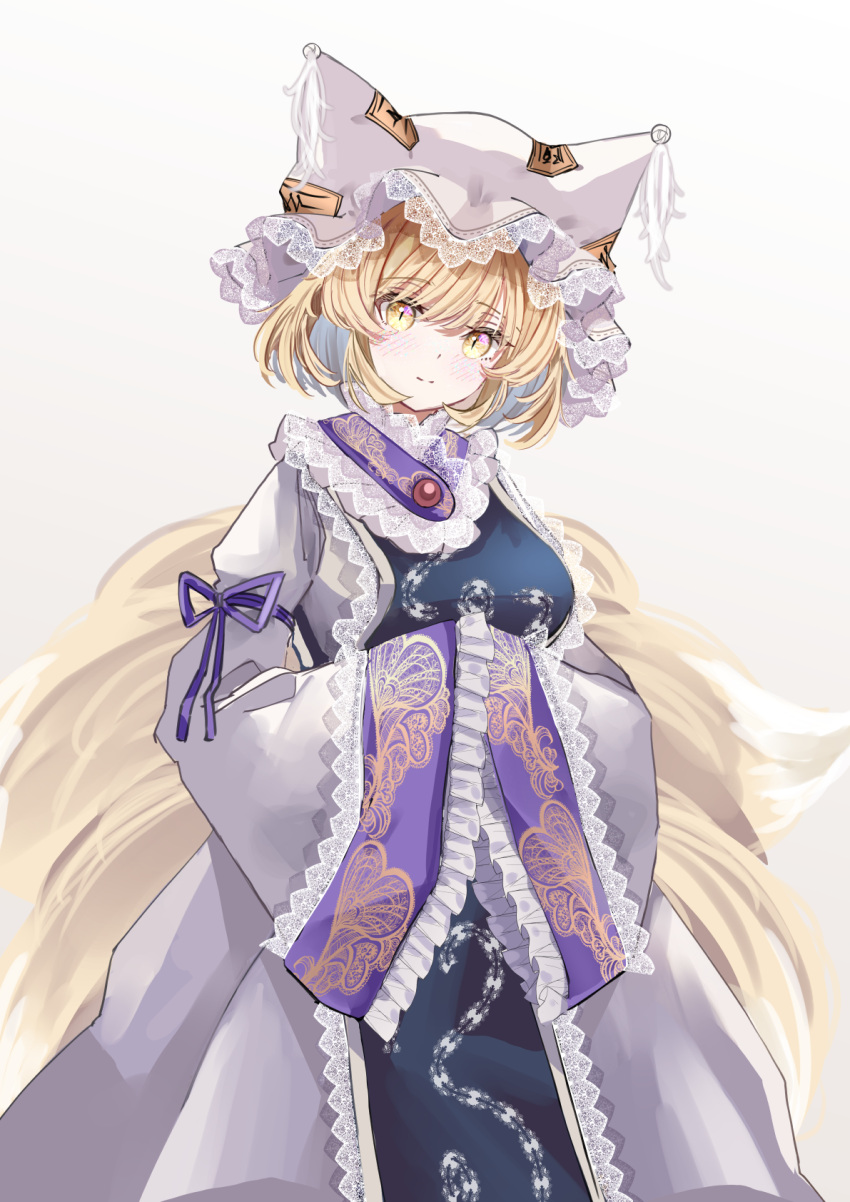 1girl animal_ears blonde_hair blush closed_mouth dress fox_ears fox_tail frilled_sleeves frills gradient_background hat highres mob_cap multiple_tails sarasadou_dan short_hair sleeves_past_fingers sleeves_past_wrists solo tabard tail touhou upper_body white_dress white_headwear wide_sleeves yakumo_ran yellow_eyes
