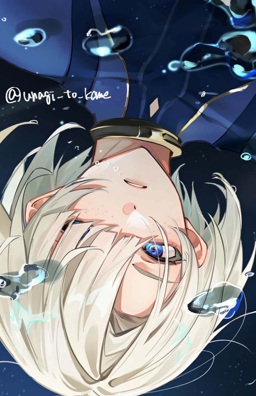 1boy air_bubble androgynous asymmetrical_bangs blonde_hair blue_coat blue_eyes blunt_bangs bubble coat freckles freminet_(genshin_impact) genshin_impact gold_trim hair_over_one_eye highres looking_at_viewer male_focus no_headwear short_hair signature submerged twitter_username unagi_to_kame upper_body upside-down water