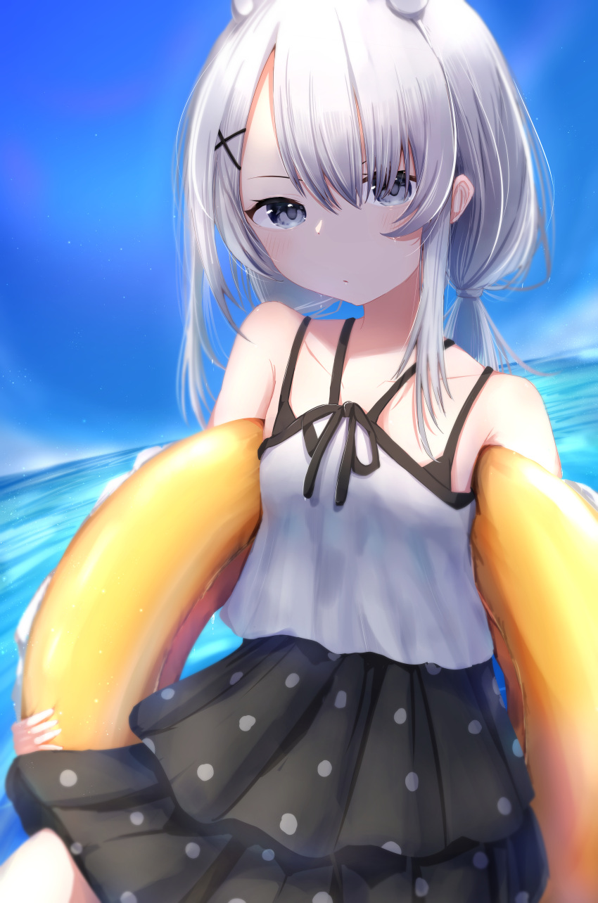 1girl absurdres black_one-piece_swimsuit blush closed_mouth collarbone day grey_eyes grey_hair hair_between_eyes hair_ornament headgear highres i-201_(kancolle) innertube kantai_collection long_hair looking_at_viewer mok4suke ocean one-piece_swimsuit outdoors polka_dot polka_dot_swimsuit solo swimsuit x_hair_ornament