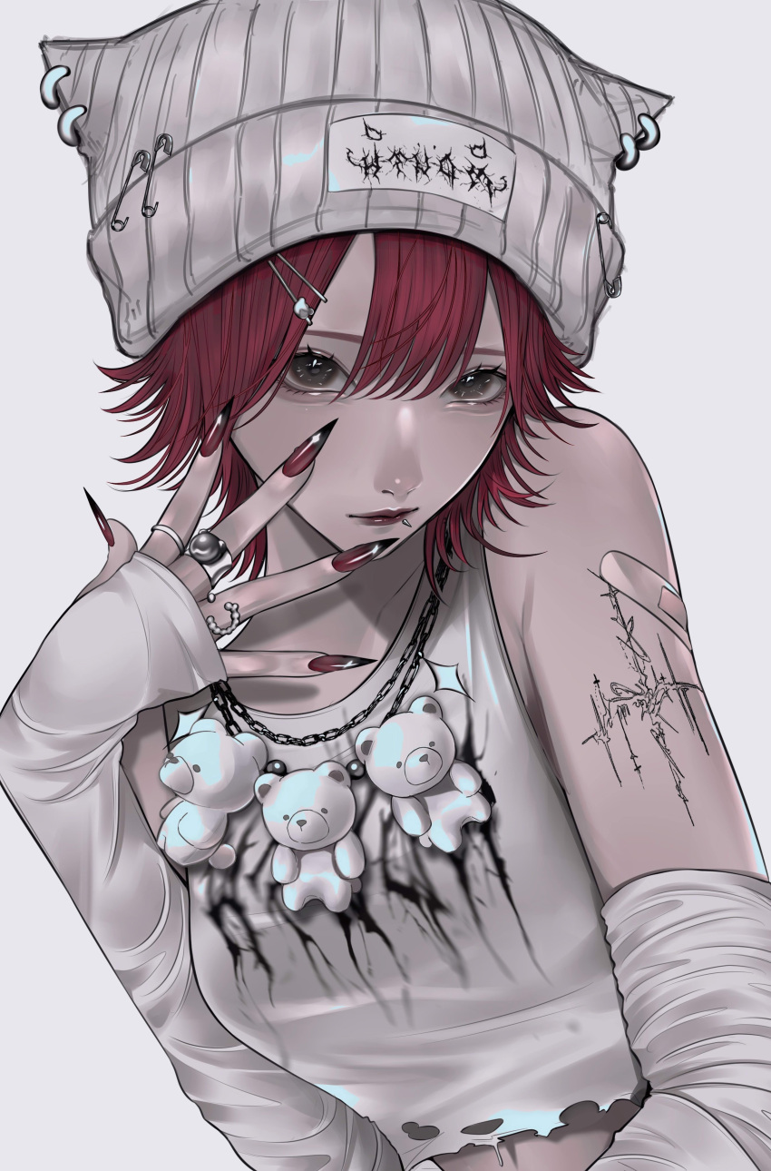 1girl absurdres arm_tattoo bandaid bandaid_on_arm beanie brown_eyes collarbone crop_top detached_sleeves fingernails grey_background grey_headwear hat highres jewelry leaning_to_the_side lip_piercing long_fingernails looking_at_viewer mano_aaa multiple_rings necklace original piercing red_lips red_nails redhead ring short_hair sleeves_past_wrists smirk solo stuffed_animal stuffed_toy tank_top tattoo teddy_bear white_tank_top