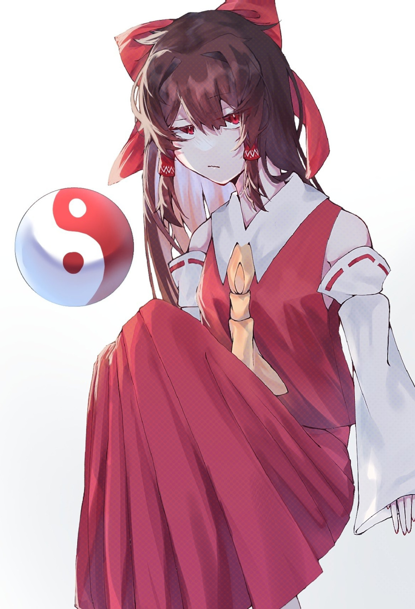 1girl :/ ascot bare_shoulders bow breasts brown_hair closed_mouth commentary_request detached_sleeves eyes_visible_through_hair feet_out_of_frame hair_bow hair_intakes hair_tubes hakurei_reimu half-closed_eyes highres jitome knees_up long_hair long_sleeves looking_at_viewer mochi_mugi orb red_bow red_eyes red_skirt red_vest sanpaku simple_background sitting skirt sleeves_past_wrists small_breasts solo touhou very_long_hair vest white_background wing_collar yellow_ascot yin_yang yin_yang_orb