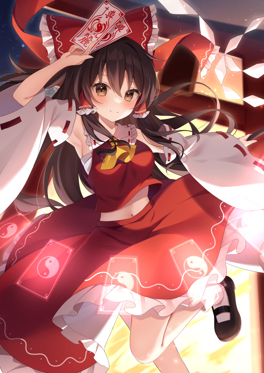 1girl ascot bare_shoulders black_footwear blush bow brown_eyes brown_hair closed_mouth detached_sleeves frilled_skirt frills hair_between_eyes hair_bow hair_tubes hakurei_reimu highres holding japanese_clothes long_hair miy@ nontraditional_miko ofuda red_bow red_skirt ribbon-trimmed_sleeves ribbon_trim shoes sidelocks skirt smile socks solo torii touhou white_sleeves white_socks wide_sleeves yellow_ascot
