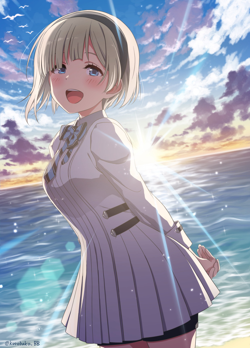 1girl absurdres arms_behind_back beach bike_shorts bird black_hairband blonde_hair blue_bow blue_eyes blue_sky blush bow breasts clouds cowboy_shot dot_nose dress from_side hair_over_one_eye hairband highres idolmaster idolmaster_starlit_season kurobako_bb large_breasts lens_flare long_sleeves looking_at_viewer ocean okuzora_kohaku open_mouth outdoors seagull short_hair sky smile solo standing striped striped_bow sunlight sunrise teeth twitter_username upper_teeth_only white_dress