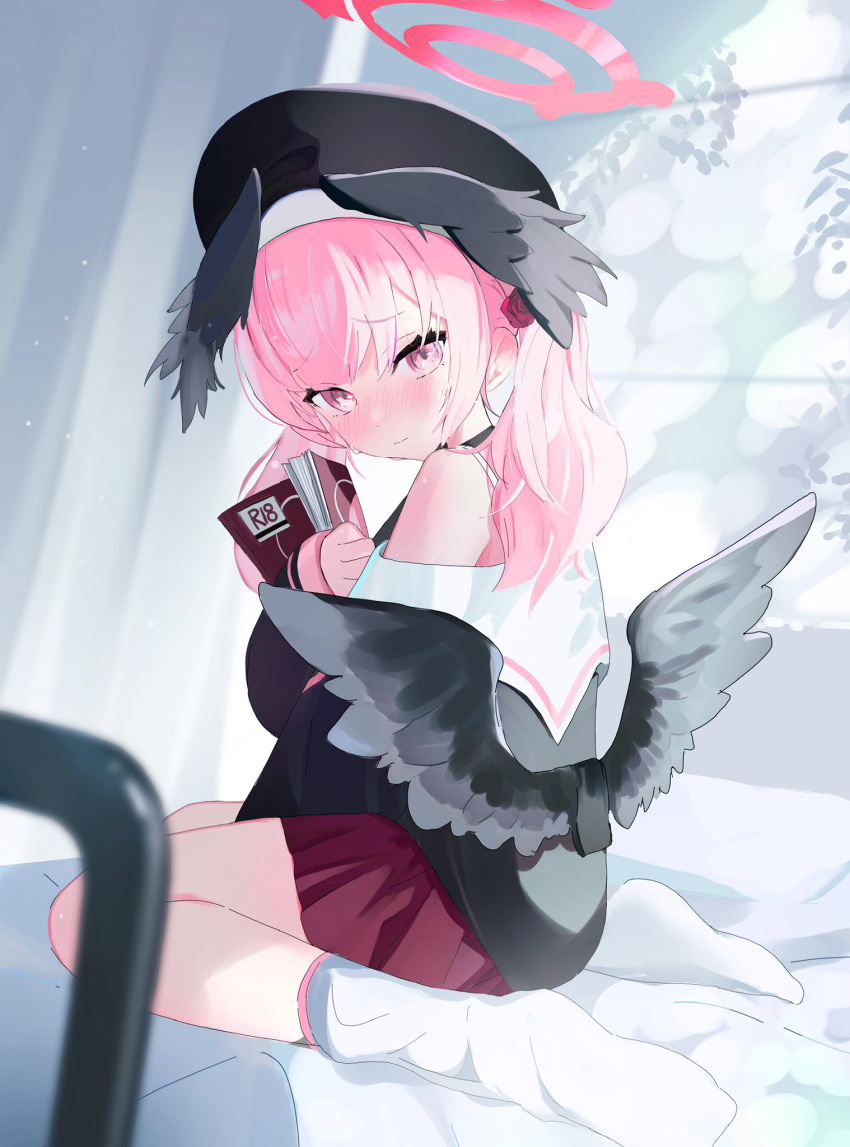 1girl beret black_footwear black_shirt black_wings blue_archive blush book bra_strap commentary_request feathered_wings from_side full_body furrowed_brow halo hat head_wings highres holding holding_book koharu_(blue_archive) long_hair looking_at_viewer low_wings manga_(object) off_shoulder on_bed pink_eyes pink_hair red_skirt sankichi_(croquette_crab) shirt single_bare_shoulder sitting skirt socks solo sweatdrop twintails wariza white_socks wings
