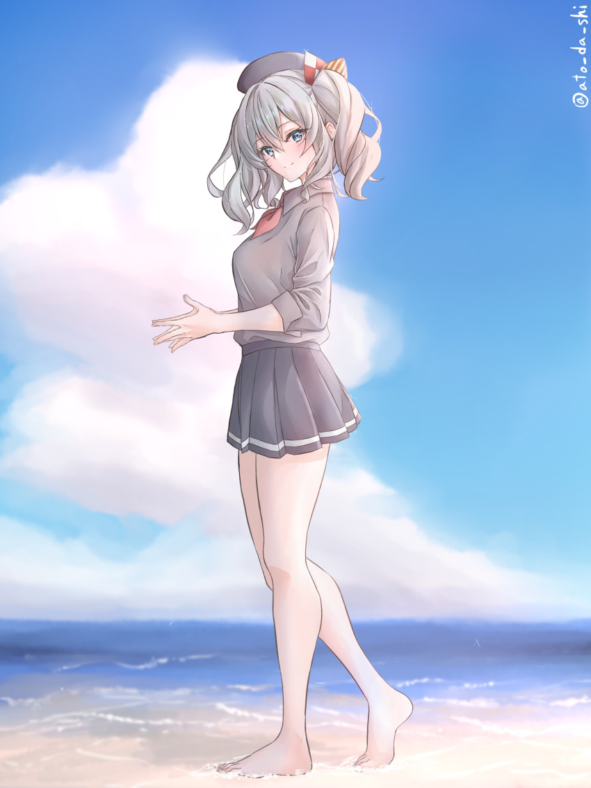 1girl absurdres atodashi barefoot beach beret black_headwear black_skirt blue_eyes blue_sky breasts clouds collared_shirt day from_side full_body grey_hair grey_shirt hat highres kantai_collection kashima_(kancolle) large_breasts looking_at_viewer miniskirt neckerchief ocean outdoors pleated_skirt red_neckerchief shirt sidelocks skirt sky smile solo standing twintails wavy_hair