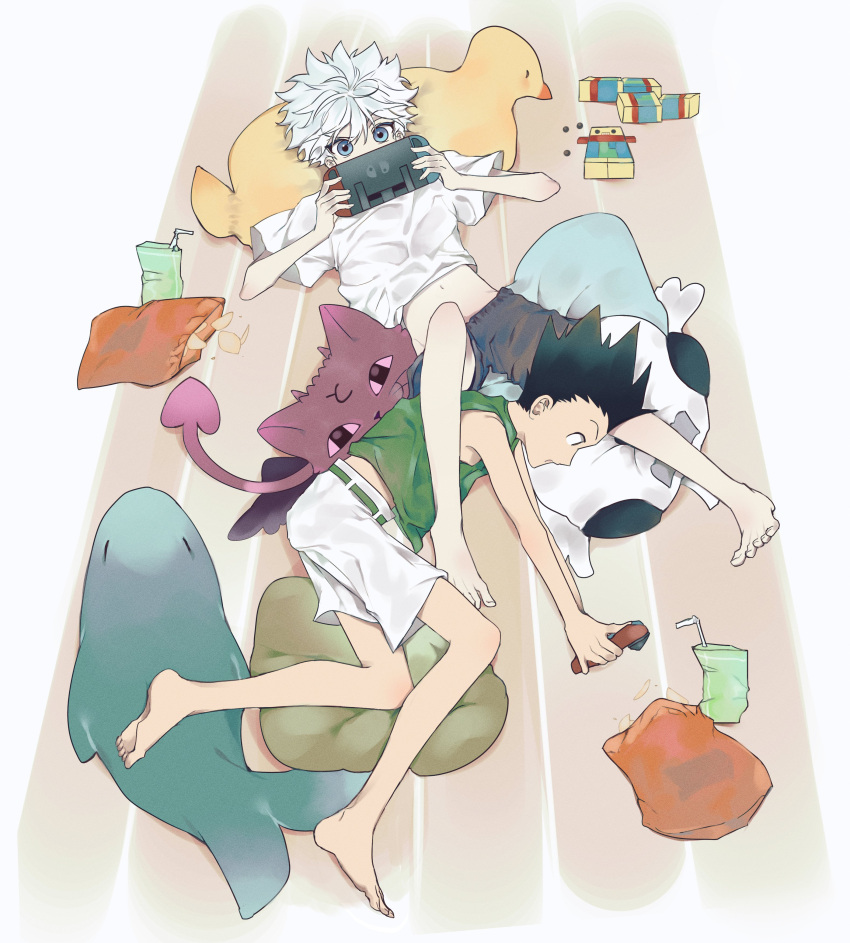 2boys absurdres barefoot blue_eyes child chips_(food) commentary_request dotori4924 food from_above gon_freecss green_shirt highres hunter_x_hunter juice_box killua_zoldyck lying male_focus multiple_boys nintendo_switch on_back on_side shirt shorts white_hair white_shirt wooden_floor
