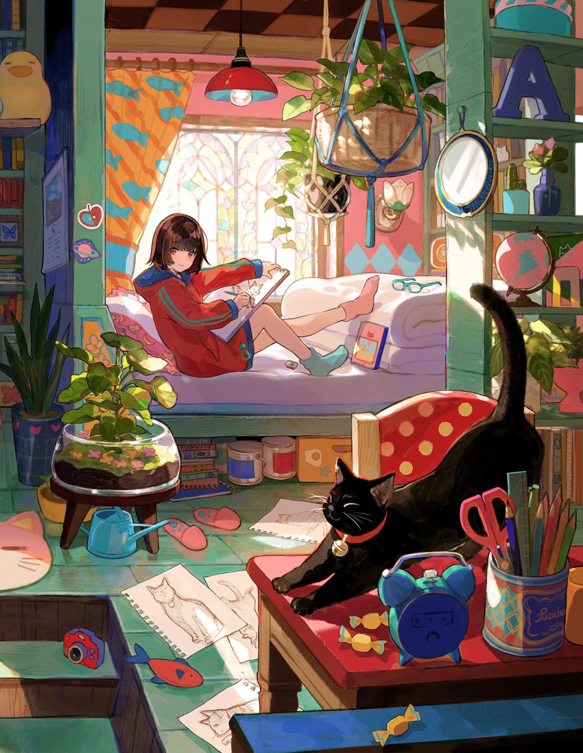 1girl alarm_clock asymmetrical_legwear basket black_cat book brown_hair c: candy cat clock curtains food fuzichoco highres holding holding_pencil hood hood_down hoodie indoors light_bulb long_sleeves looking_at_viewer mismatched_legwear mismatched_socks original paper pencil pillow plant potted_plant red_eyes red_hoodie scissors short_hair sitting smile table watering_can window