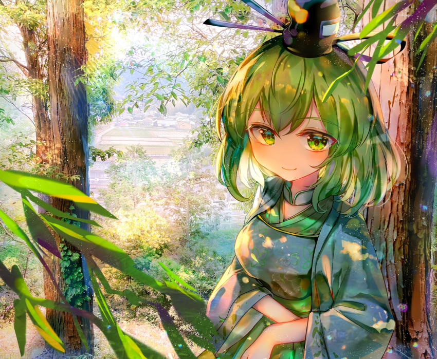 1girl adapted_costume black_headwear breasts closed_mouth commentary green_eyes green_hair hat highres itsumizu large_breasts long_sleeves looking_at_viewer outdoors short_hair smile soga_no_tojiko solo tate_eboshi touhou tree